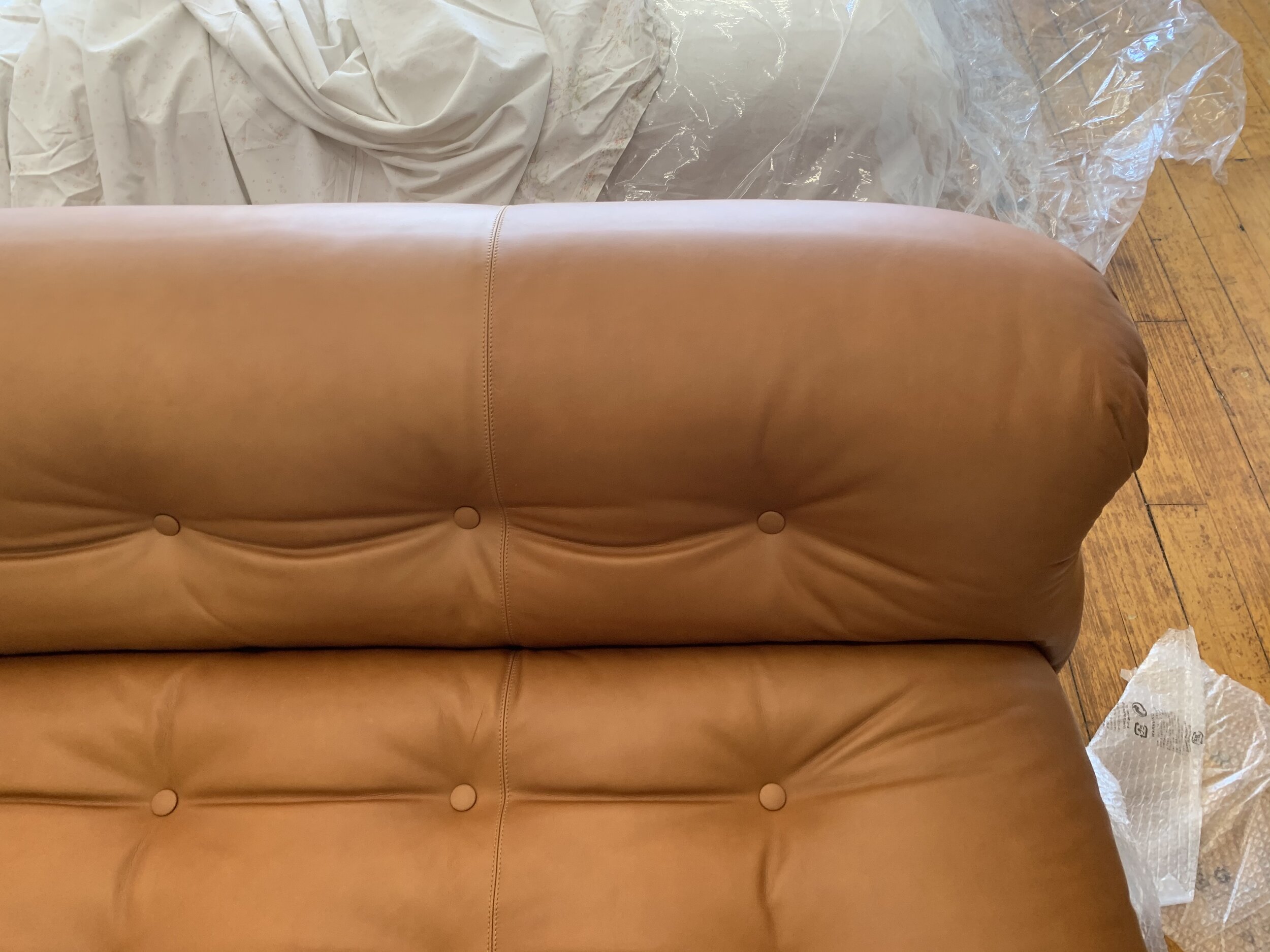 Vintage Soriana Sofa and Ottoman in cognac leather | leather tufted seat close up