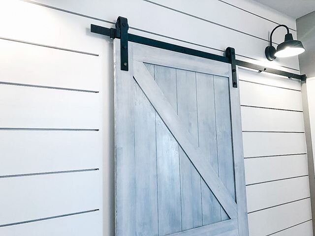 I love the combination of shiplap walls with a sliding farmhouse door!