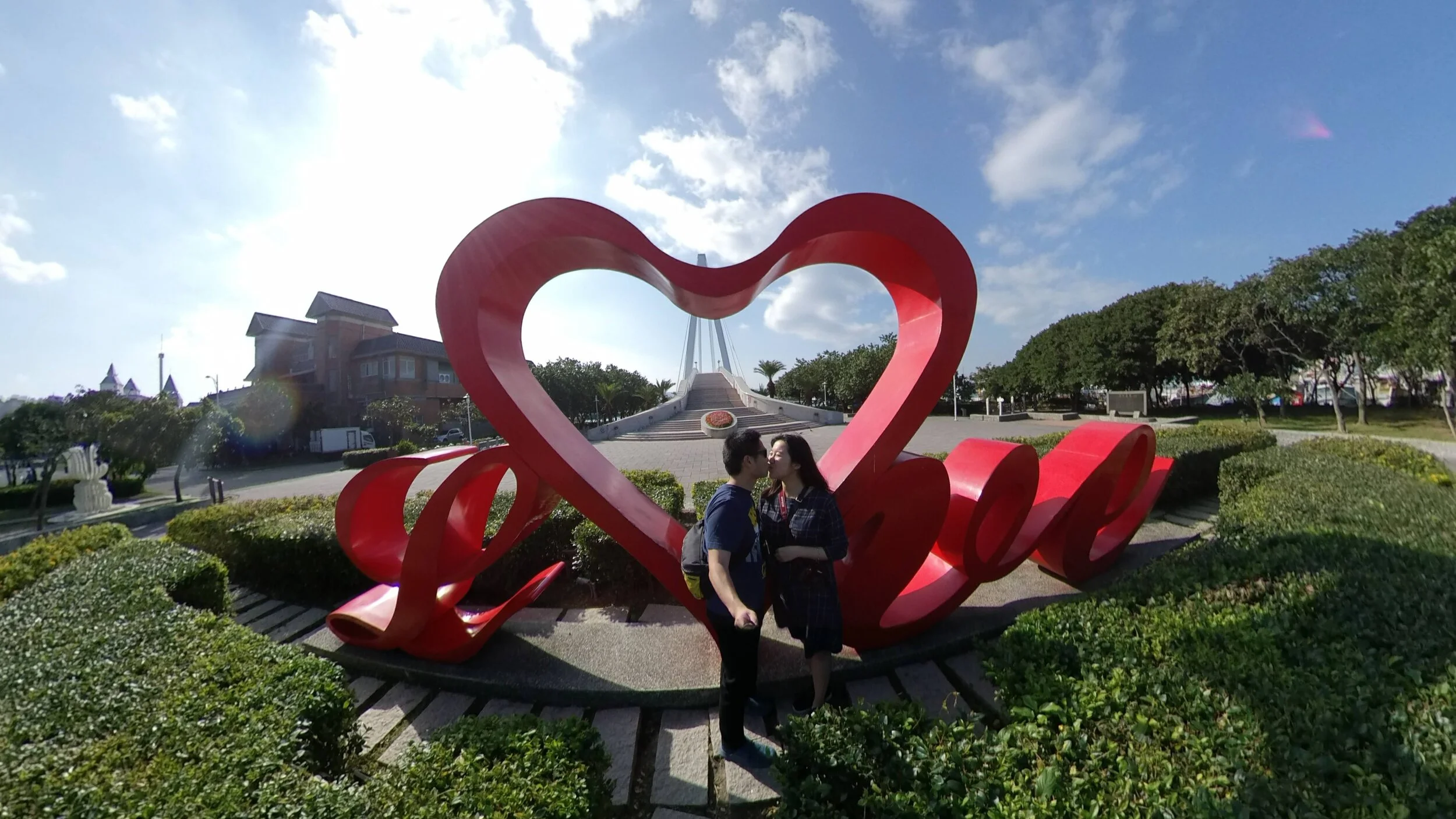 Kissing in front of Lover’s Bridge. Shot isn’t perfect (blocking the bridge in the back). But hey, love isn’t perfect either. ;)