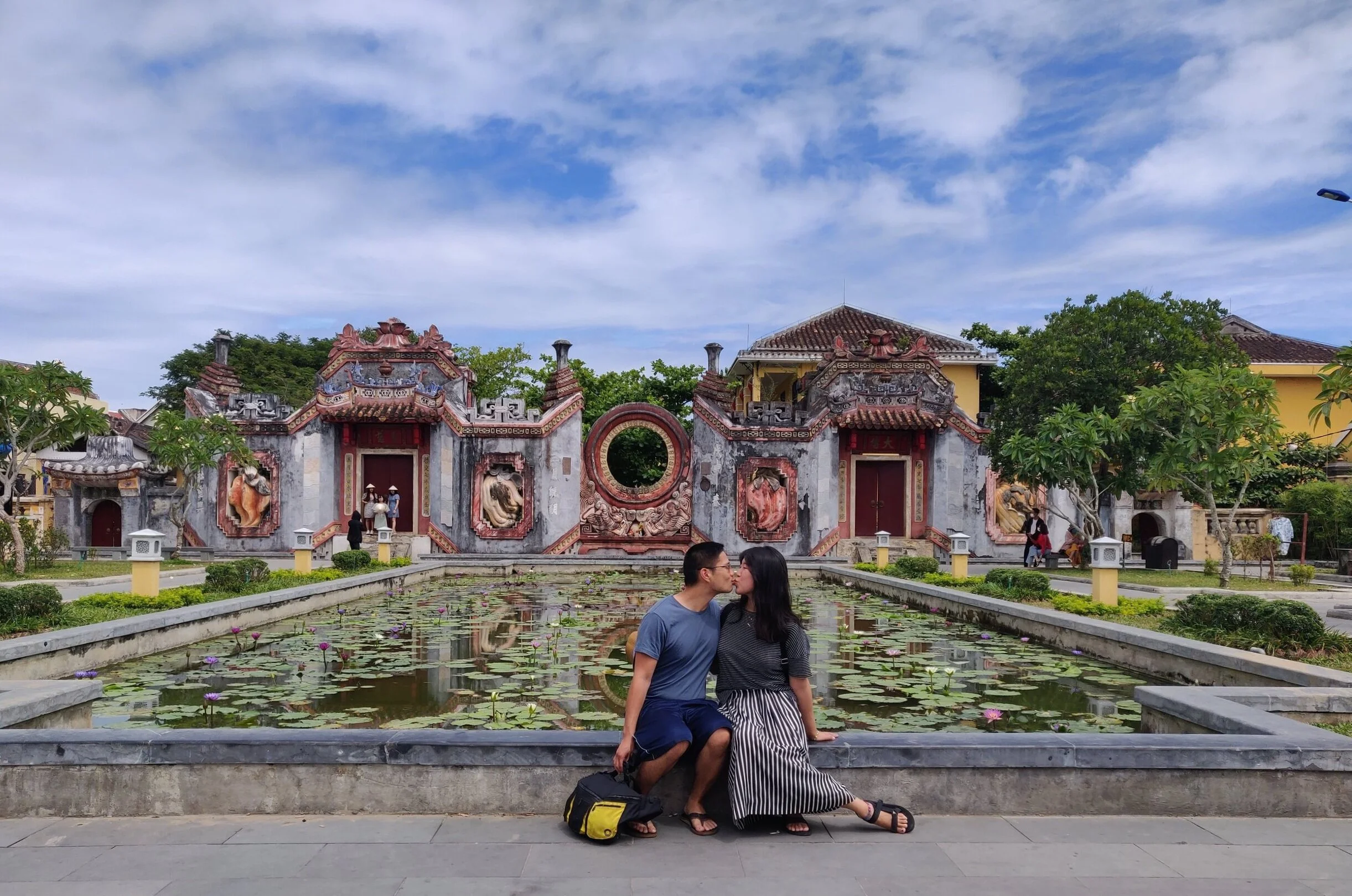 It's good luck to kissy face in front of the Tam Quan Chua Ba Mu Chinese temple and reflecting pool. Hoi An, Vietnam.