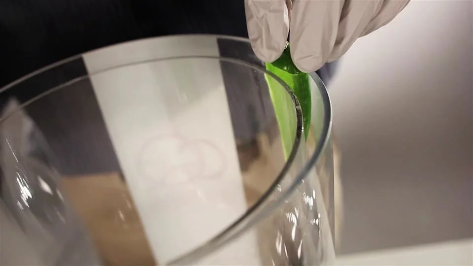 Inserting a freshly sliced jalapeño into CQ's Patented Beverage Dispenser. The jalapeño is held in place because it is positioned between the inner wall of the beverage dispenser and the outer wall of the insert, eliminating a blocked spigot