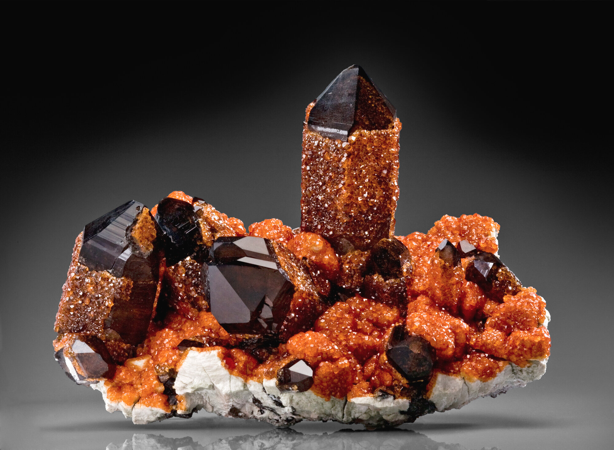  Spessartine with smoky quartz on feldspar, 18 cm, from the Wushan mine, Tongbei, Zhangzhou Prefecture, Fujian Province, China. Collected ca. 2005. Ex Chen Wei Gang collection. 