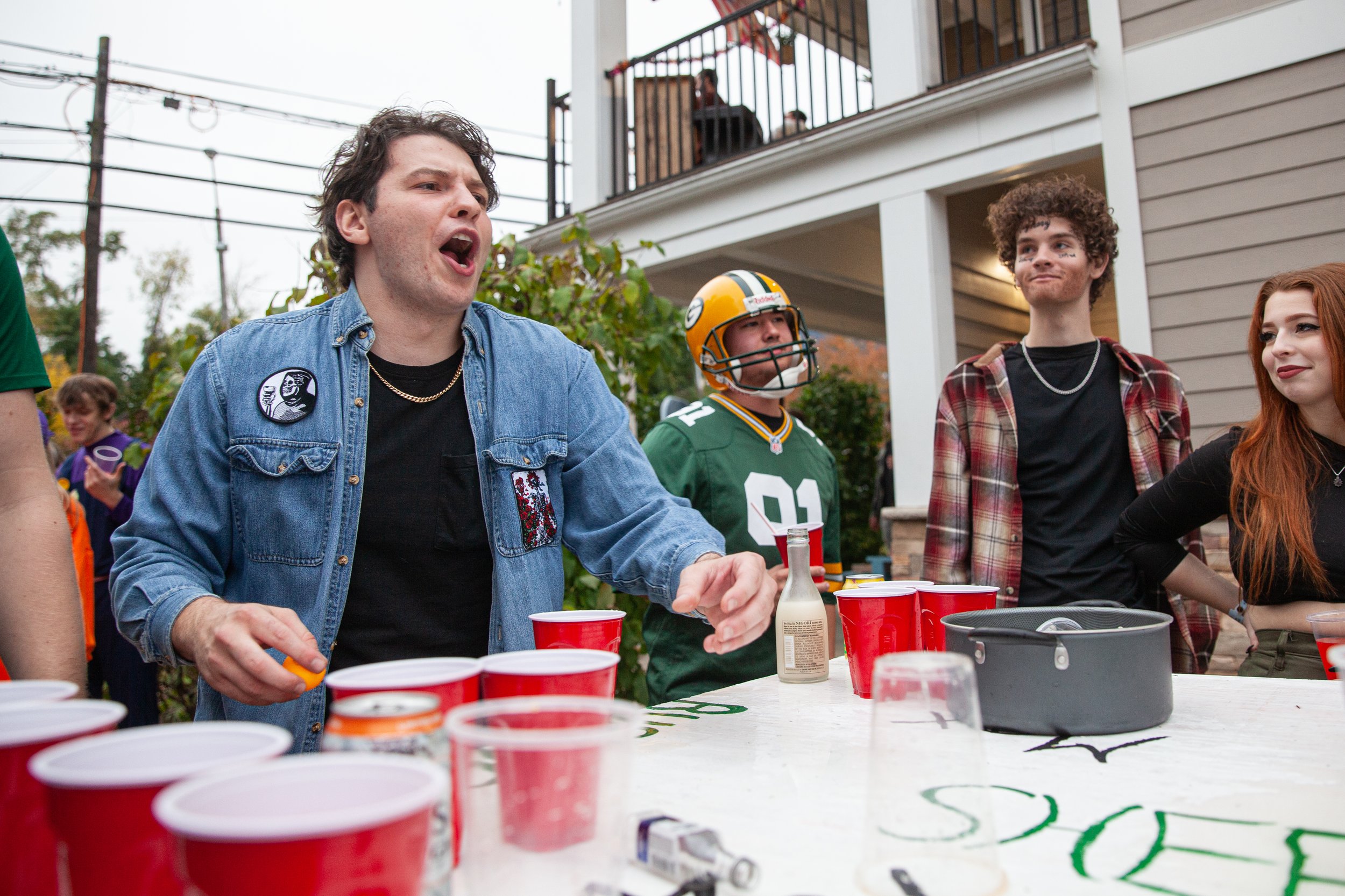  Michael Graziano, left, plays a passionate game of pong at a house party on Mill St. on Saturday, Oct. 30, 2021. Students like Graziano hosted parties at almost every house or apartment complex on Mill Street after the Athens Block Party was cancell