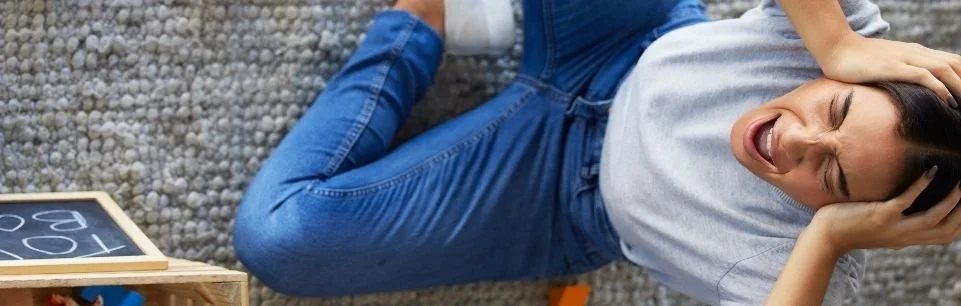 Tired ADHD mom feeling overwhelmed by parenting stress and messy house