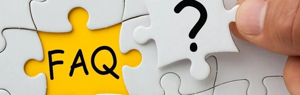 Hand holding a jigsaw puzzle piece with a question mark, representing common ADHD questions and myths
