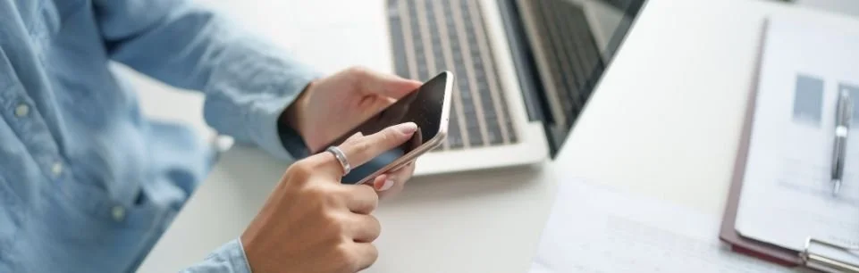 Man using smartphone at work showing ADHD distraction and focus challenges