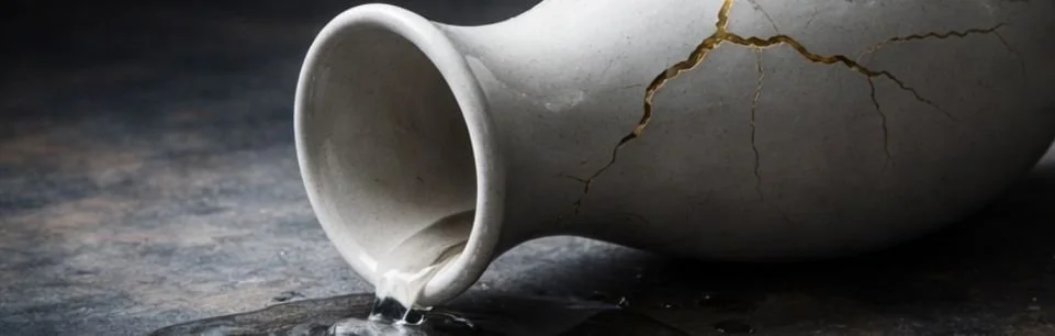 A visually cracked porcelain vase symbolizing the feeling of Adult ADHD burnout in parenting.