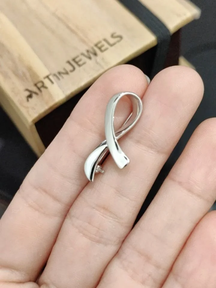 Jewelry as a different kind of statement. Wear your stand. A wanted a visible reminder of what she believes in and fights for. And so we made her this white ribbon pin, custom crafted in 14K white gold as a lasting and wearable proof of her principle