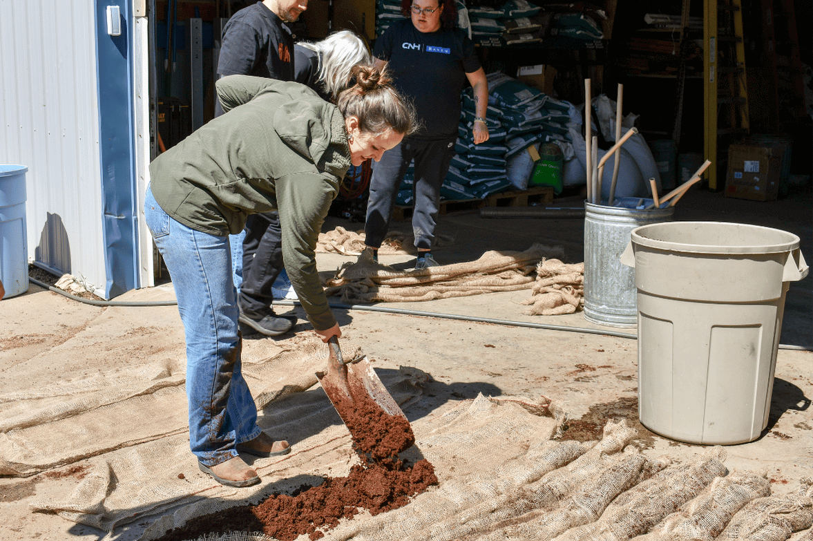 Scooping the coco coir into the burlap sacks