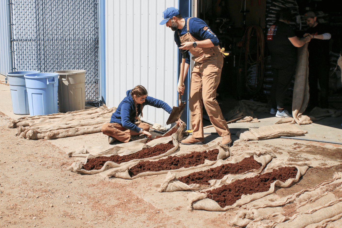 Scooping the coco coir into the burlap sacks