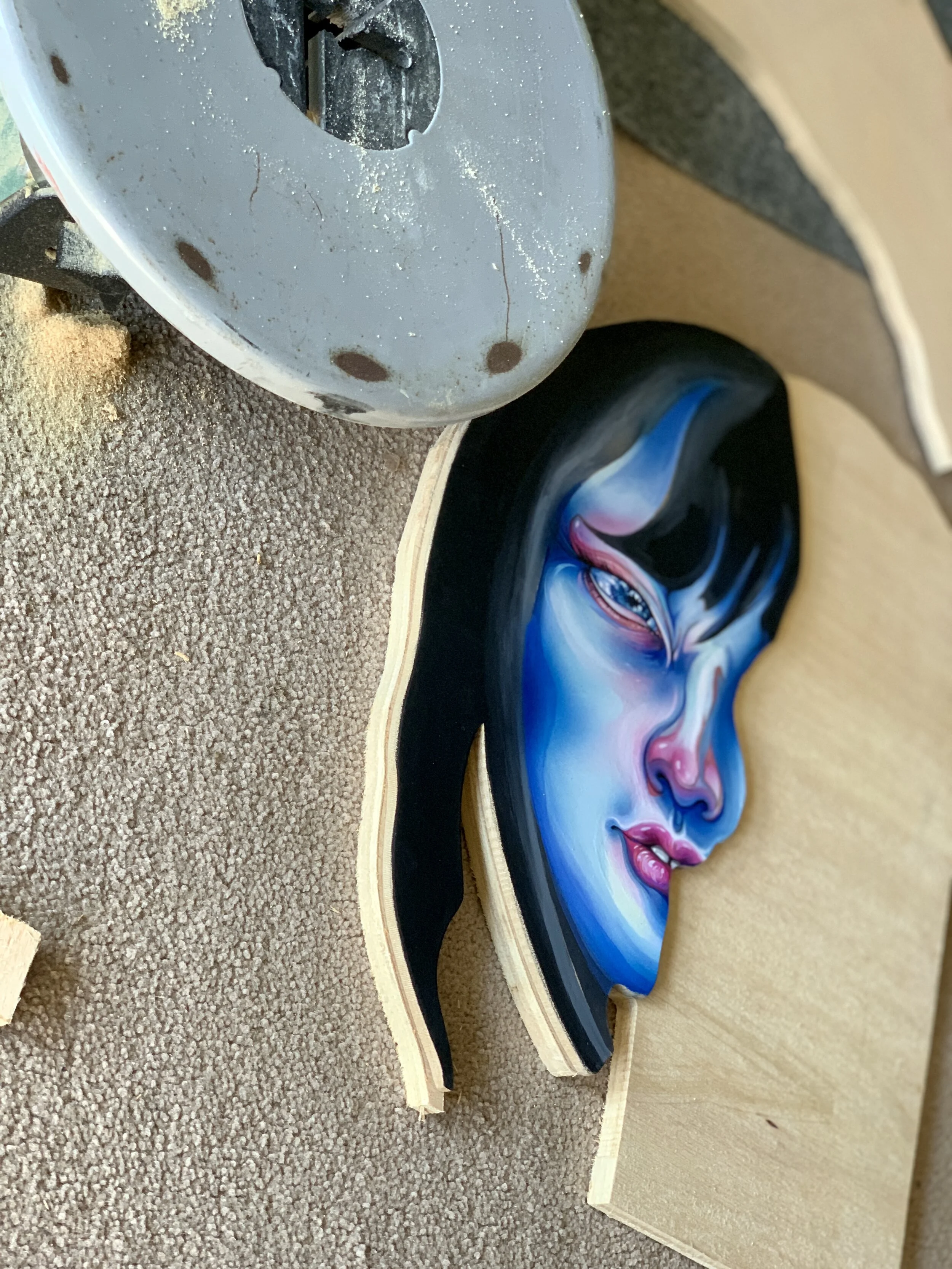 Cutting out gouache painting with saw