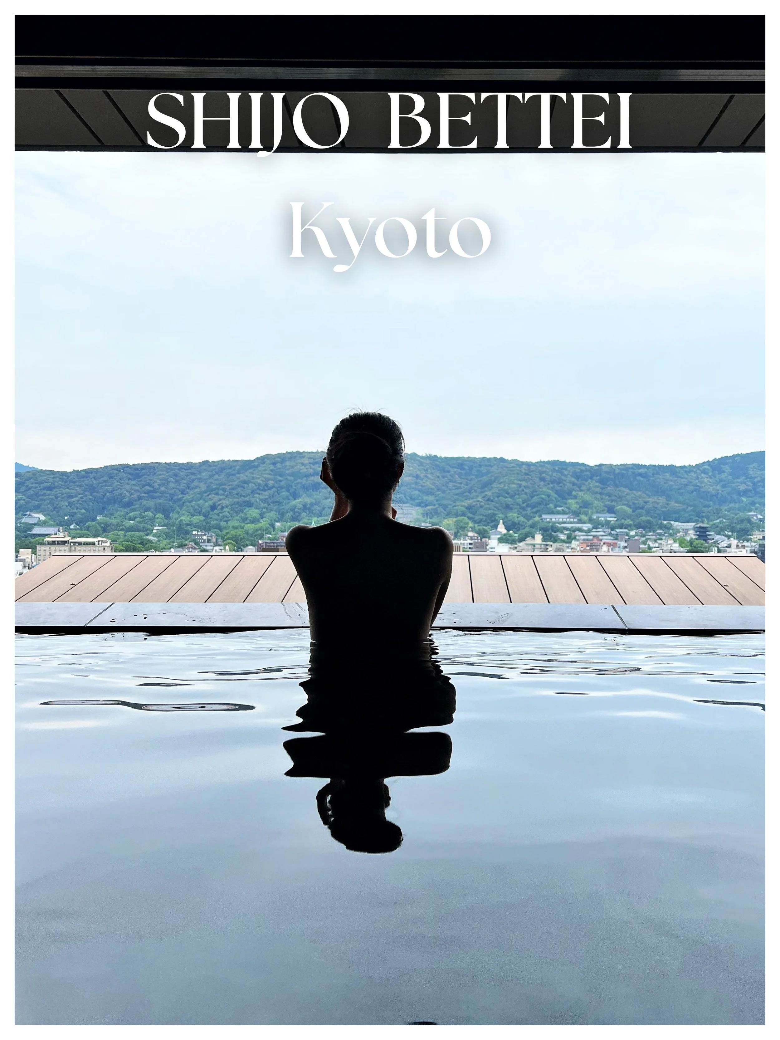 A person relaxing in an infinity pool, facing a scenic view of green hills and buildings under a cloudy sky, withed a modern structure. Text overlays say 'SHIJO BETTEM Kyoto'.