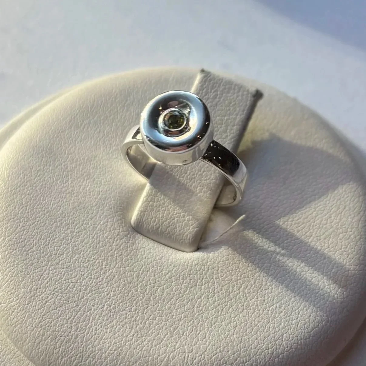  Peridot set in 14K yellow gold bezel, set in sterling silver 