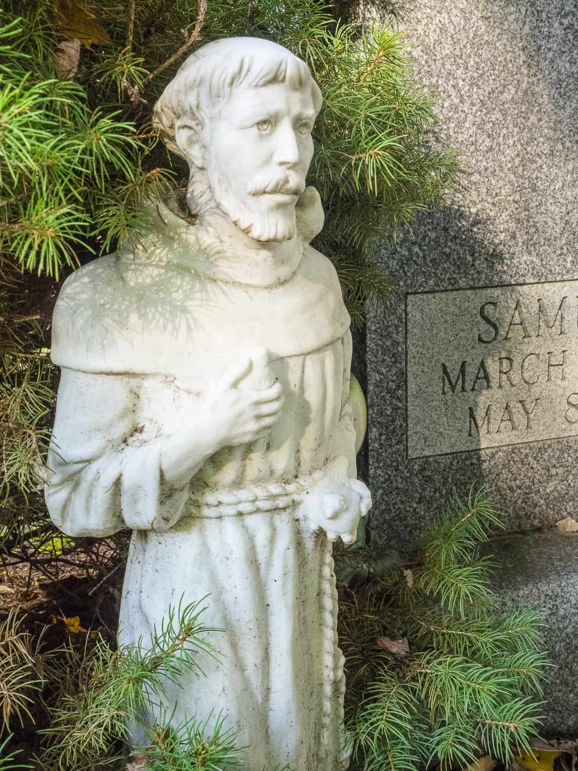 Saint Francis statue at a headstone Webster Union Cemetery