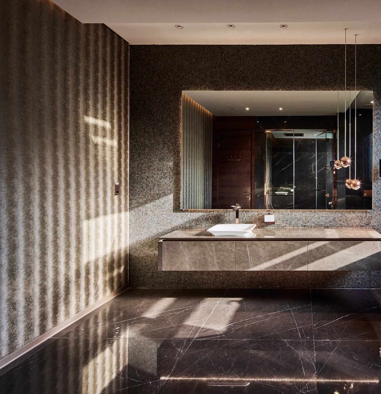 Guest bathroom with a floating stone vanity and textured patterned wall, M Villa, Dubai Hills Estate
