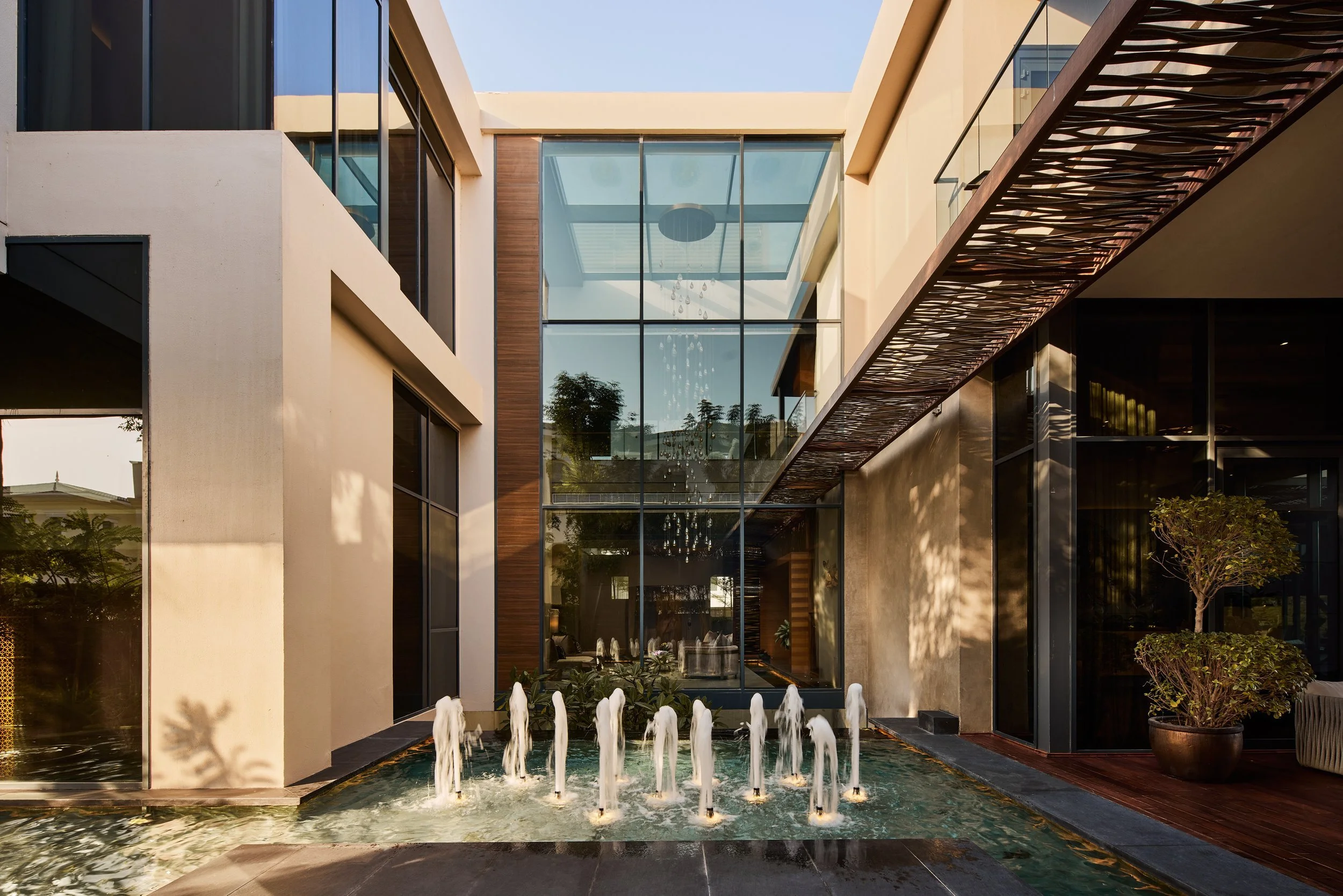 Courtyard fountain between glass-walled wings of M Villa, Dubai Hills Estate