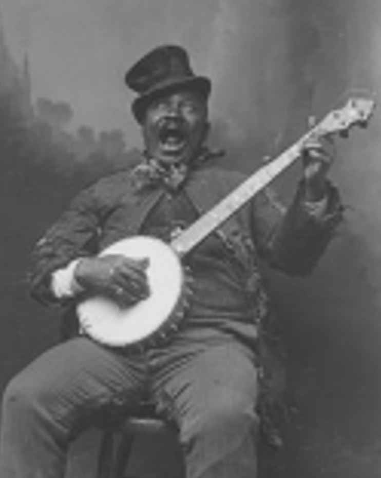 A man with a mustache wearing a military uniform and hat, sitting and playing a banjo, with an expressive face.