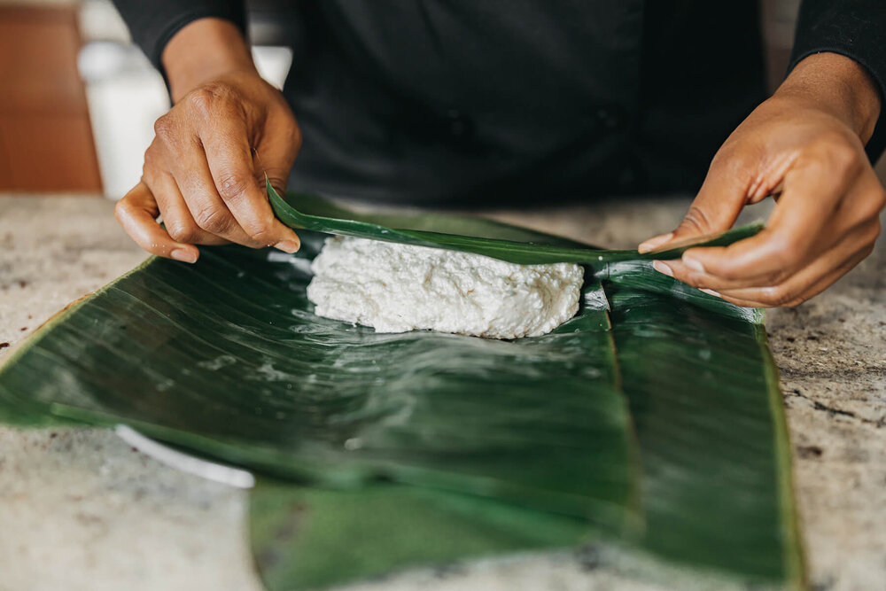 Scoop cocoyam paste into plantain leaf.