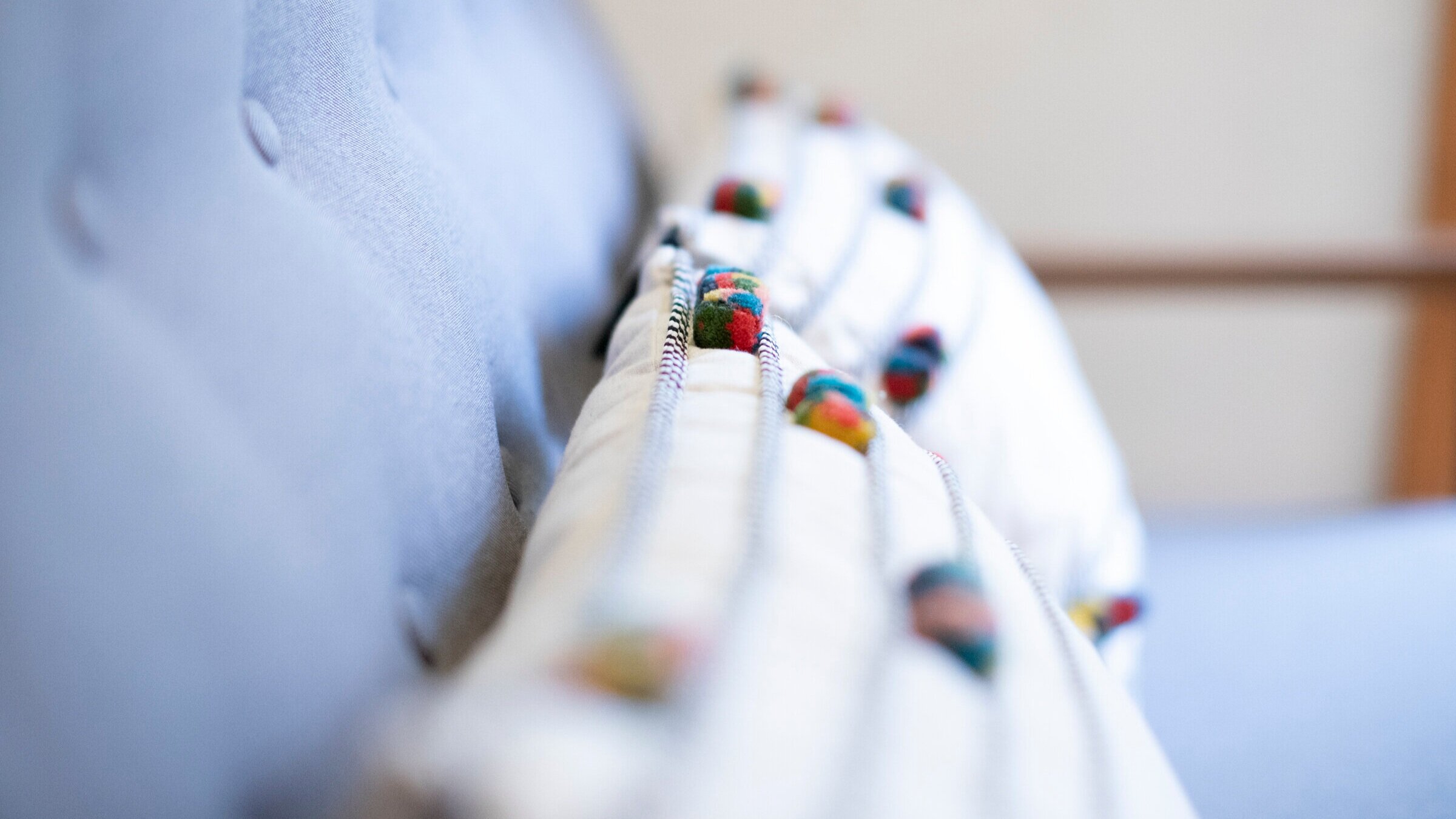  Close-up photo of pillows on a bench in one of Julie’s patient rooms in her clinic. 