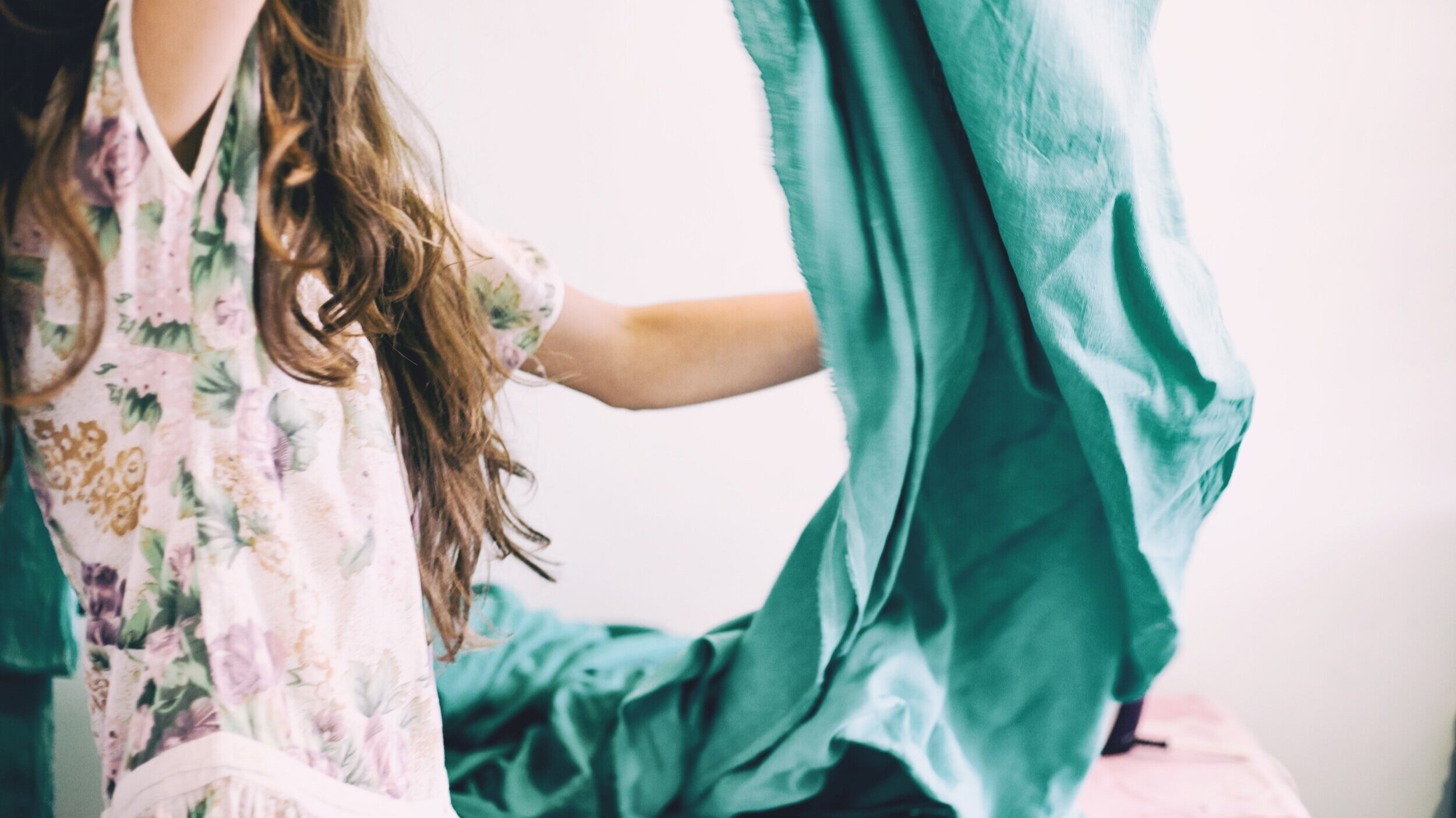  Photo of a woman folding bedding. 