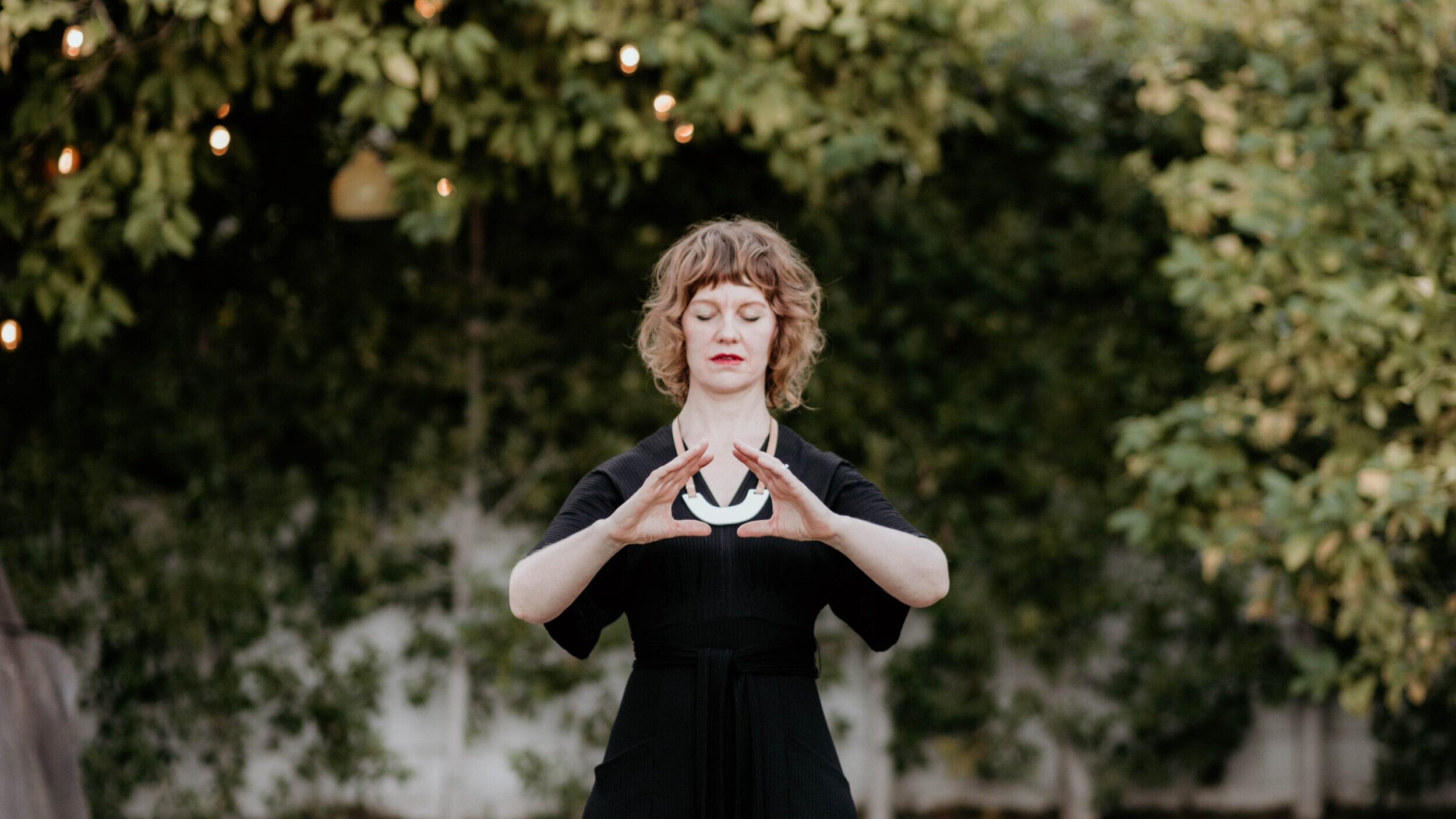  Photo of Julie practicing qi gong exercises outdoors. 