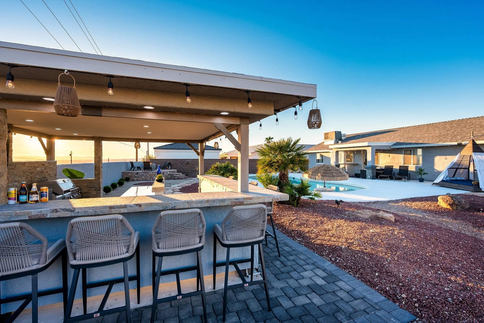 Golden hour over Lake Havasu, a cold drink in hand, and your entire outdoor kitchen ready for the night. With seating for the whole crew, a full prep area, bar setup, lighting, and a BBQ built to handle any gathering, this backyard was made for long 