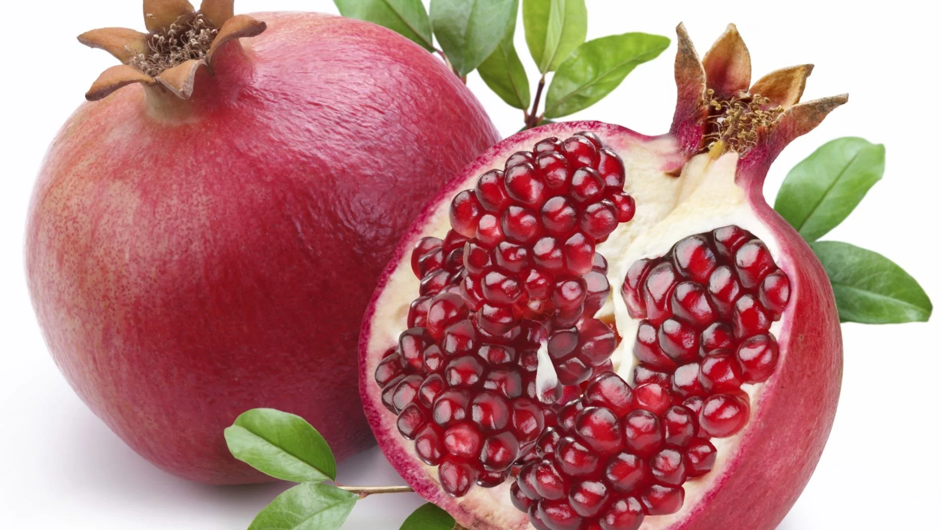 Photo of a whole pomegranate and an open pomegranate showing its seeds