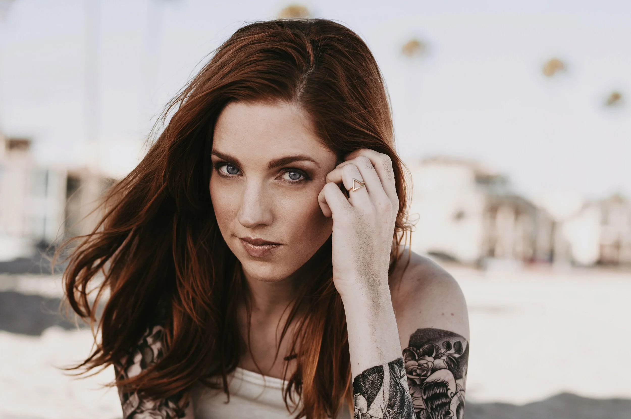 wind blown redhead with tattoos