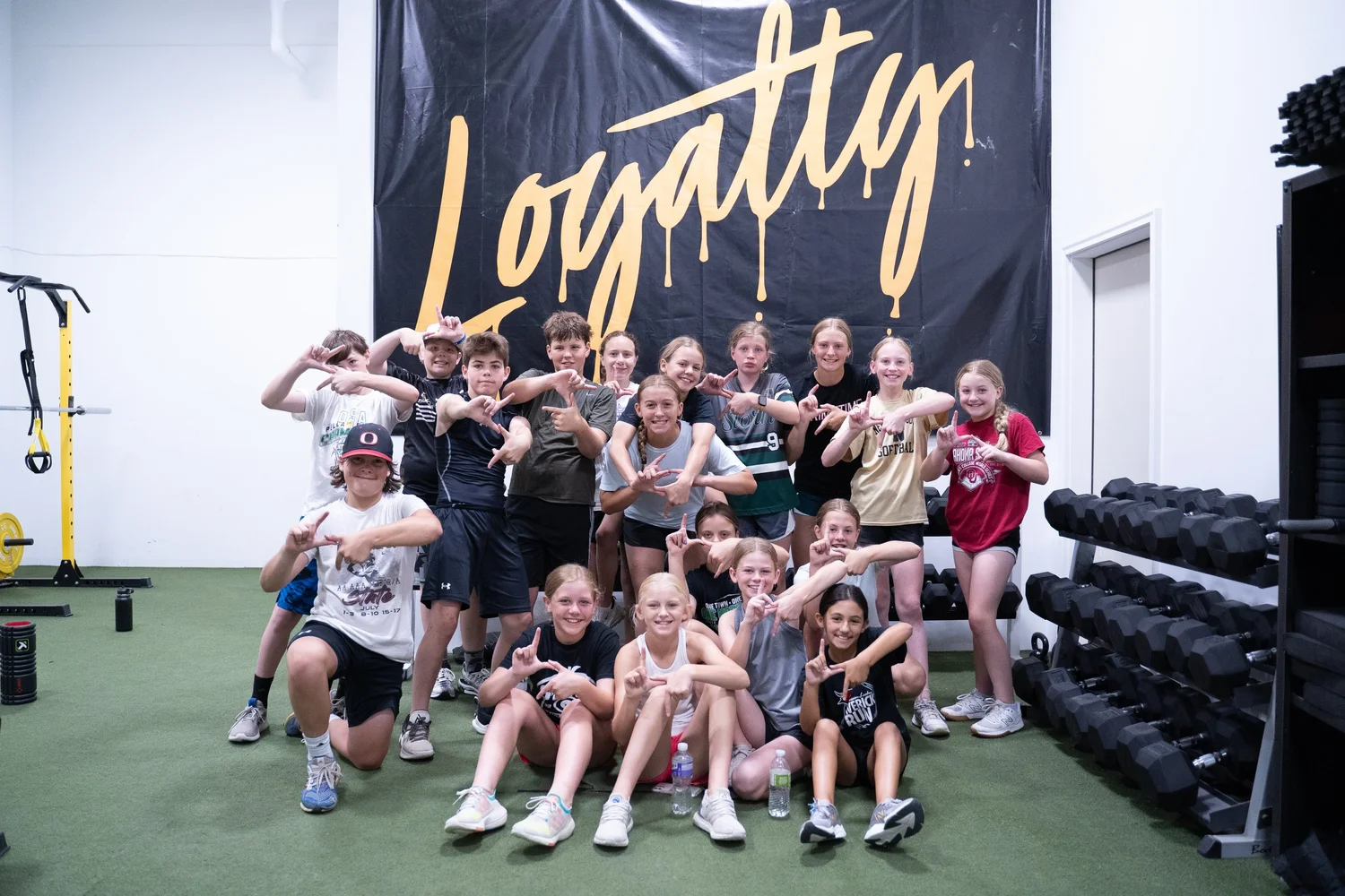 Loyalty athletes in front of the gold Loyalty banner