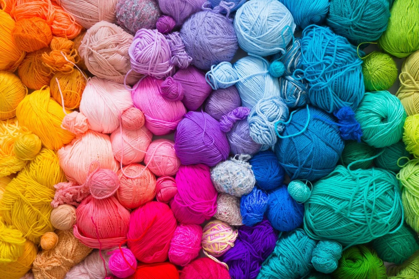 Pile-of-rainbow-yarn-in-various-colors.jpeg