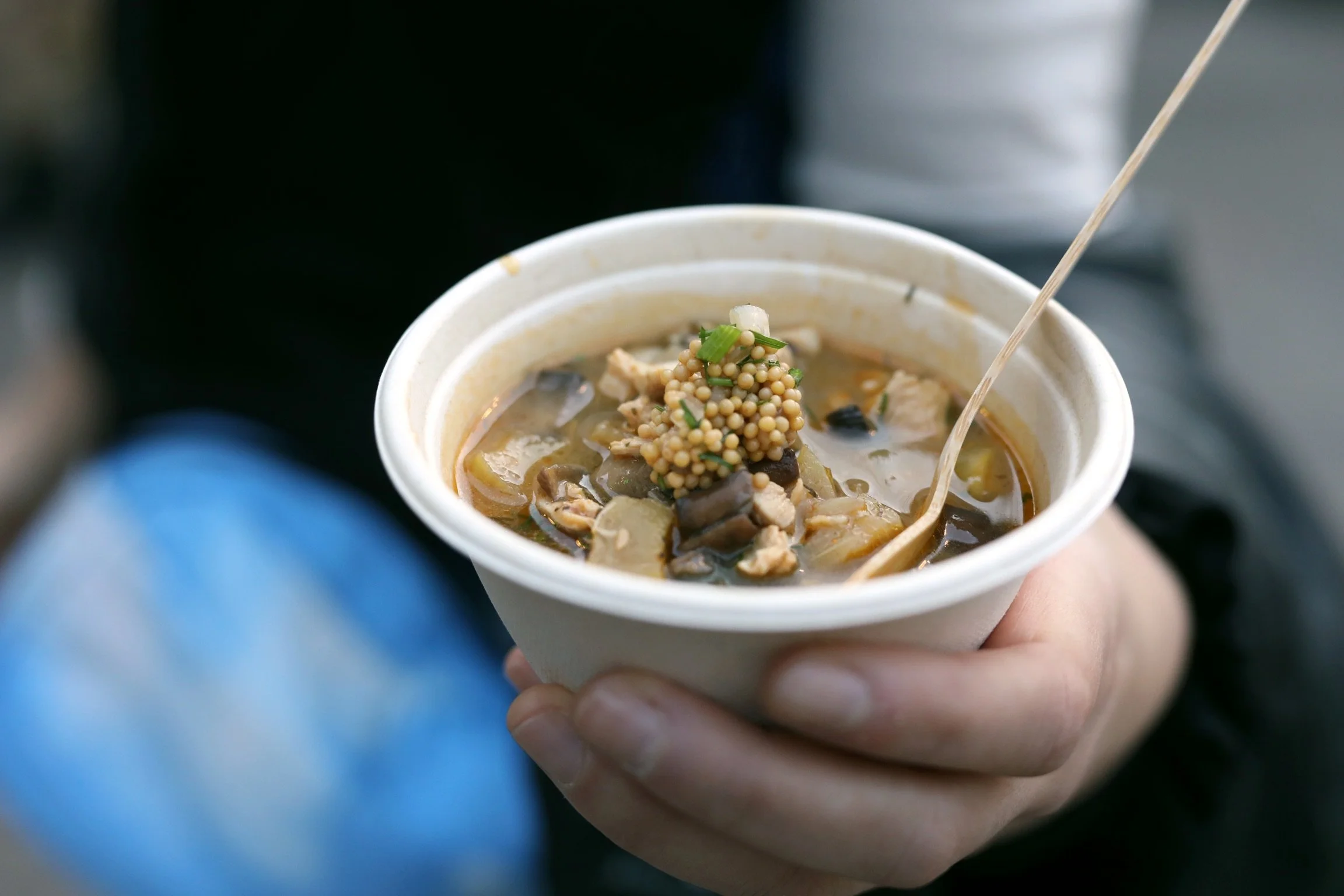 A bowl of soup in a compostable bowl