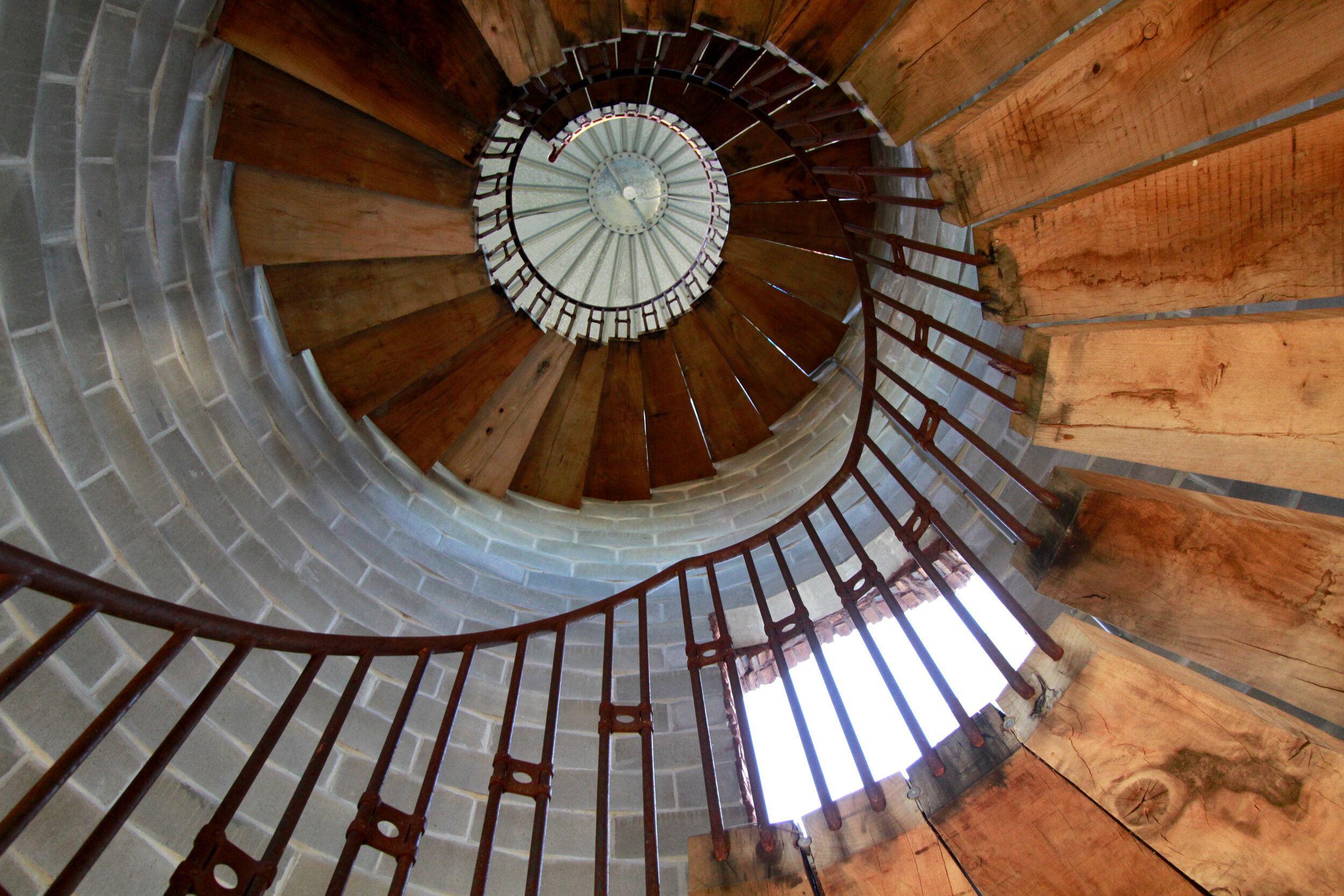 Silo, spiral staircase from top with wooden steps, iron railing