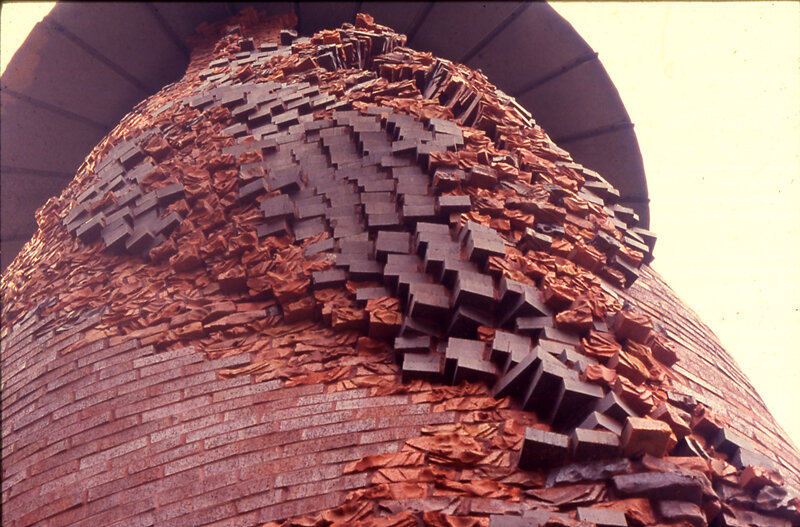 carved brick exterior of silo, resembles shingle texture
