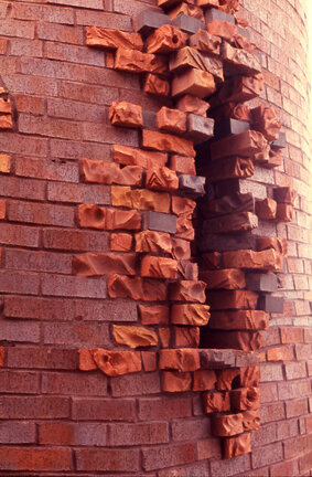 slit like opening on exterior of silo built by brick artist Michael Morgan