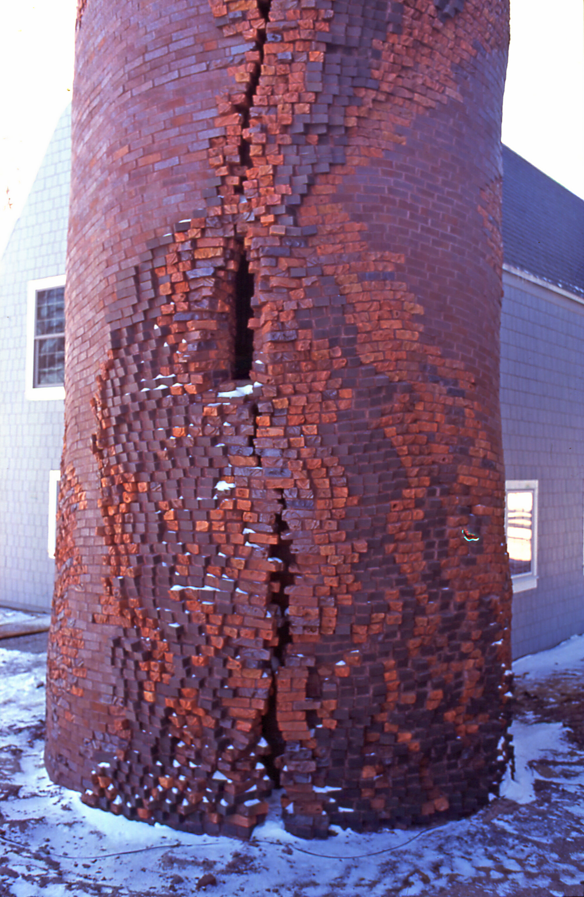 Craggy surface of silo designed by brick artist Michael Morgan