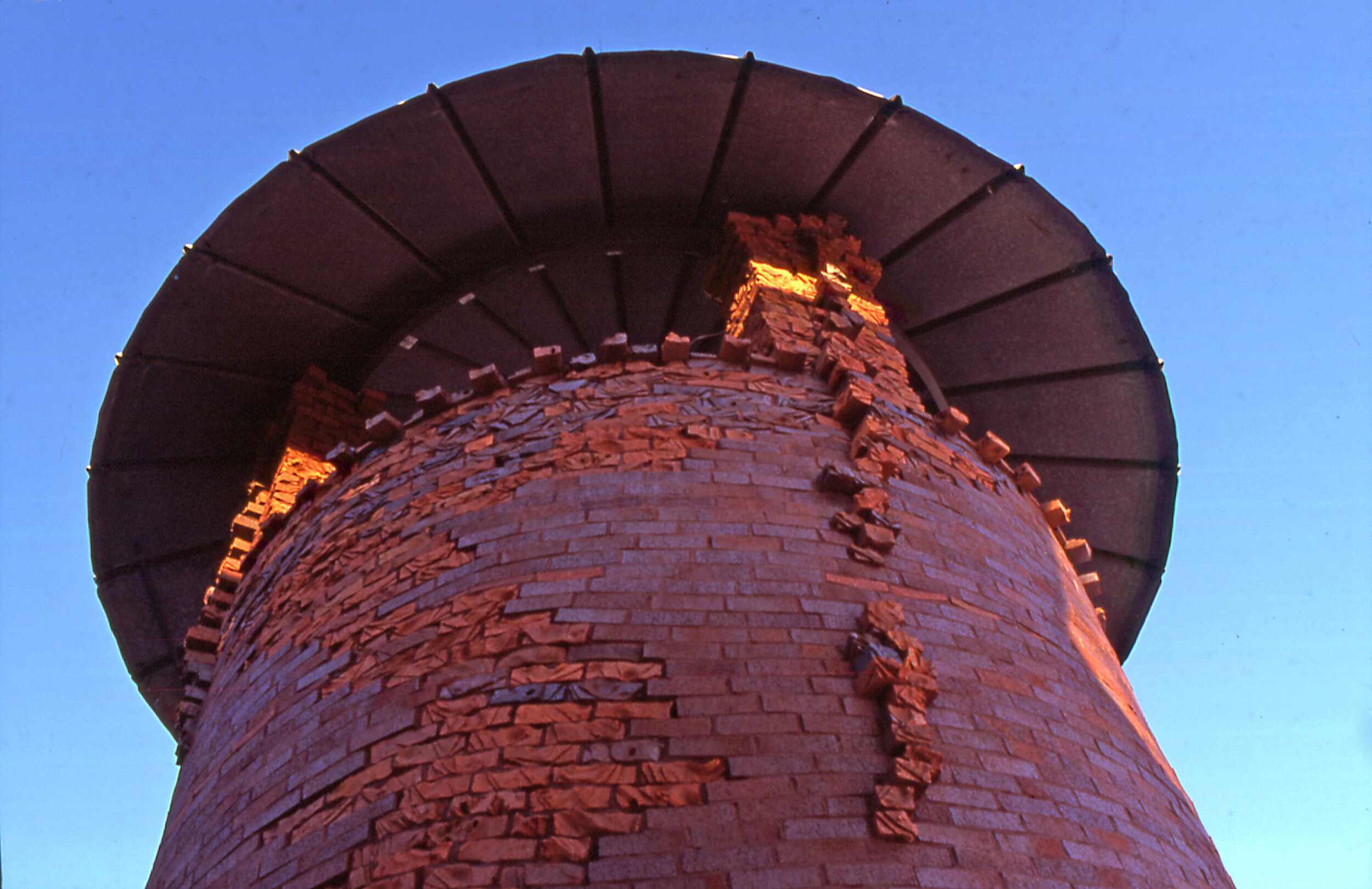 view of silo roof showing carved bricks and metal roof