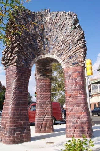 Three legged arch of carved brick stands at 33rd and Ridge Ave in Philadelphia. Commissioned by SEPTA