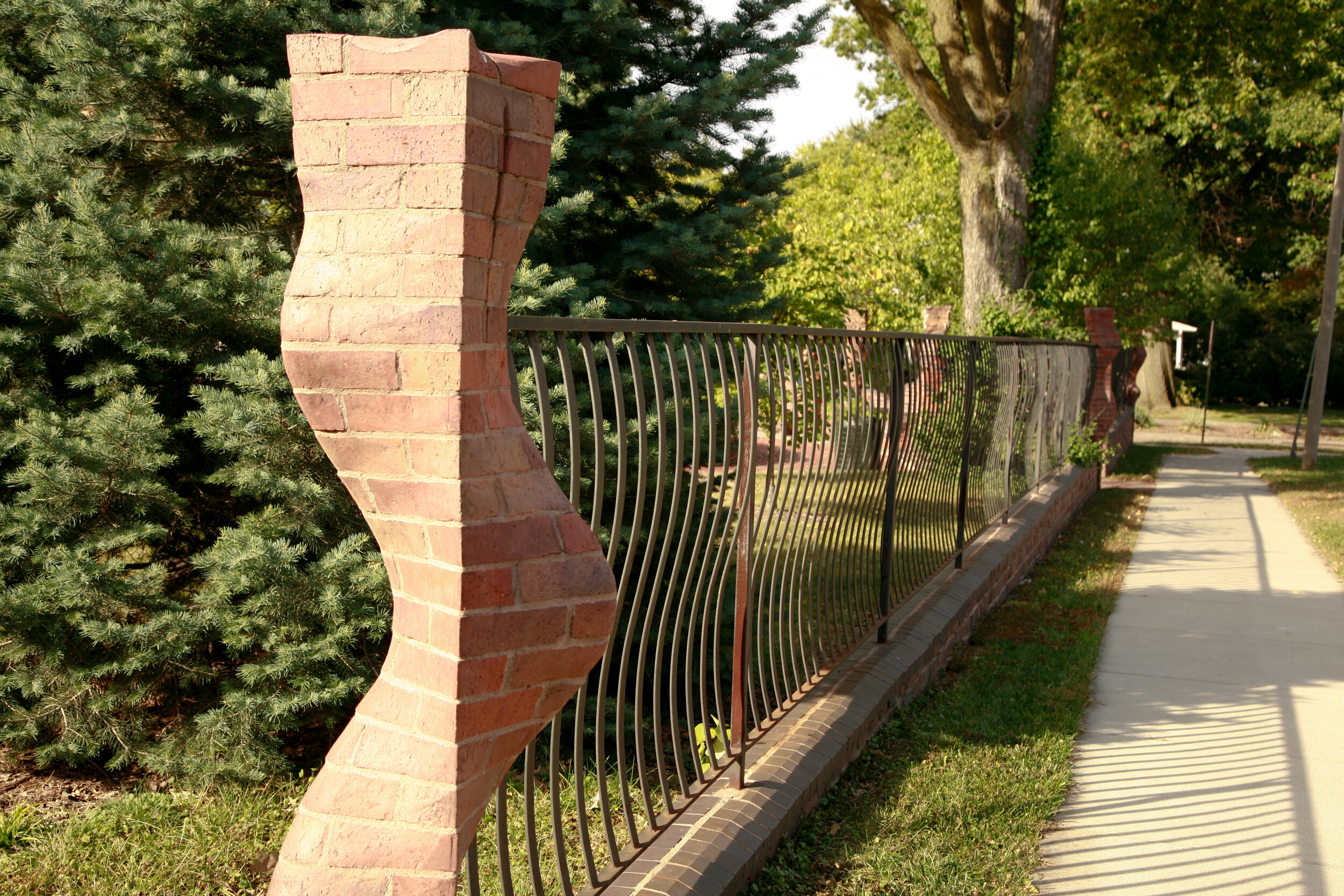 Corner column of Seven Herms sculptural fence installation