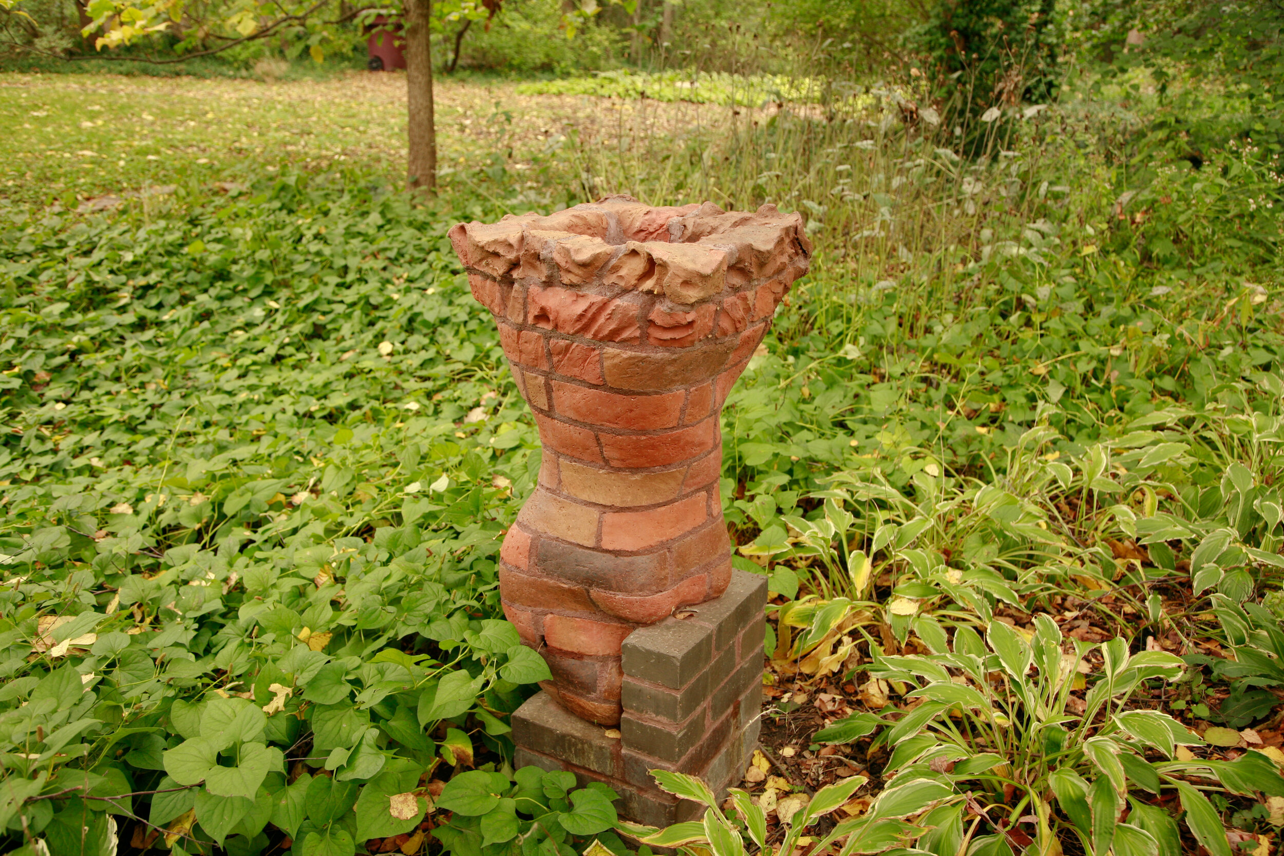 garden column of carved brick in feminine shape