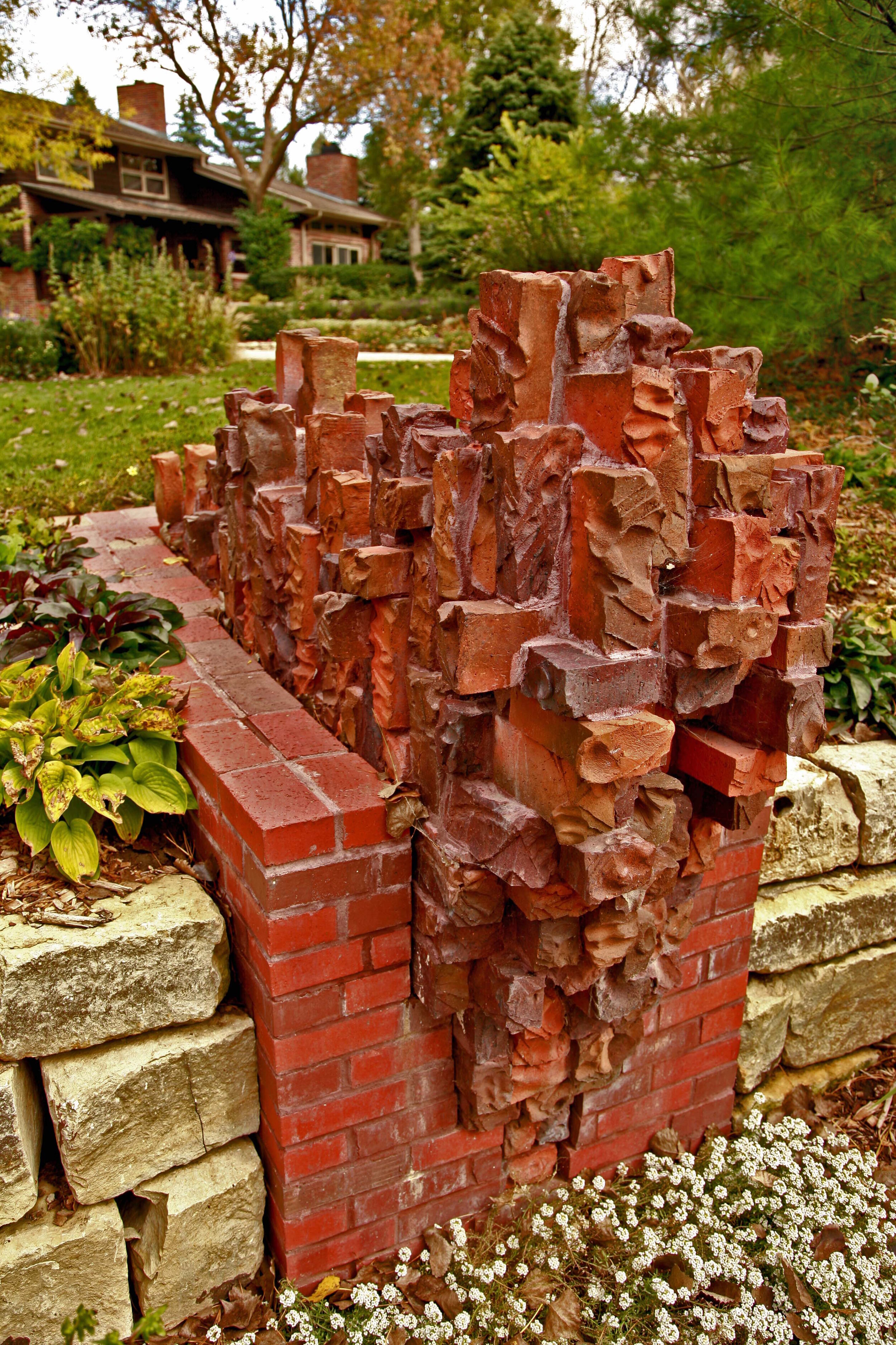 Garden wall sculpture of carved brick