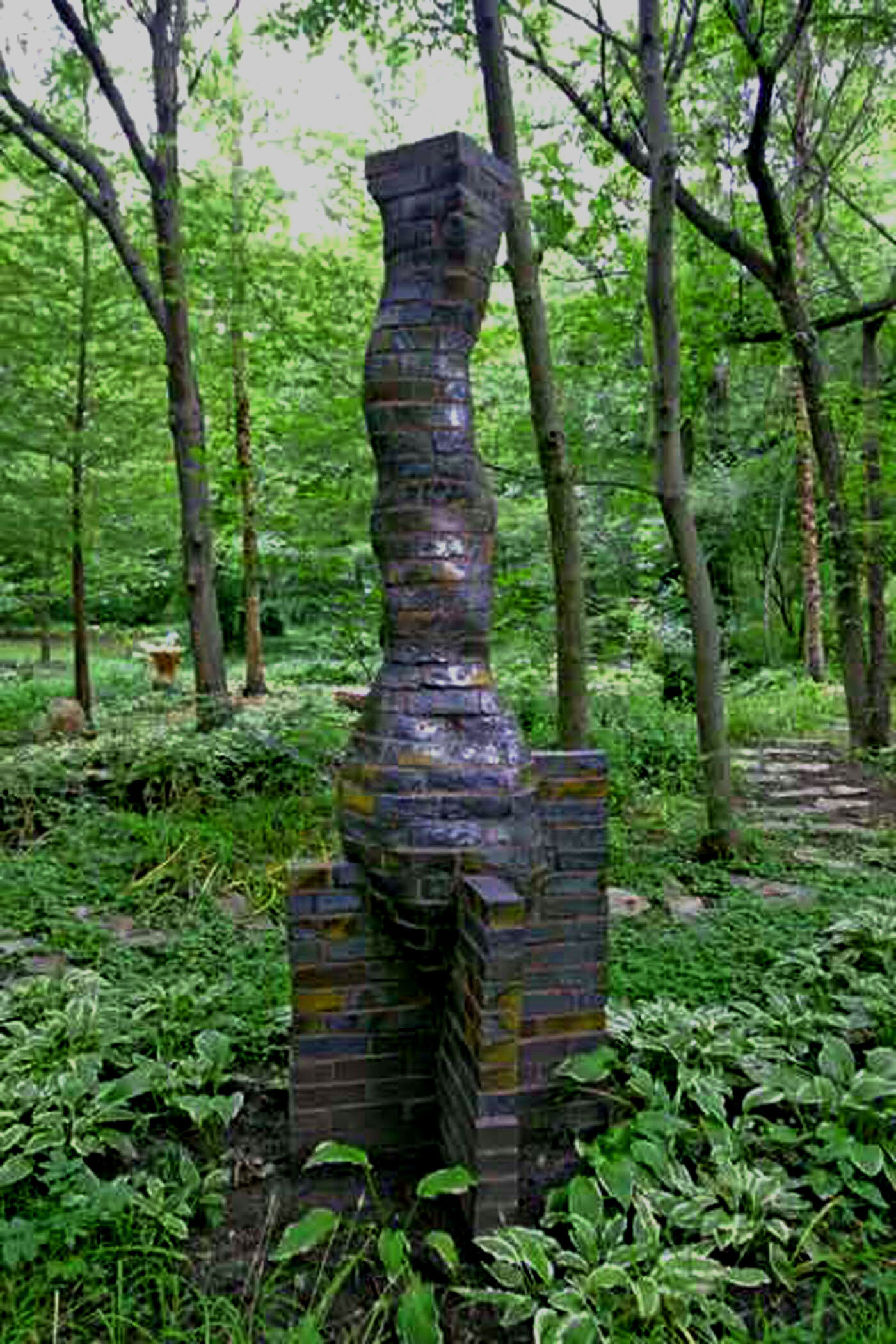 Column on buttressed pedestal in garden