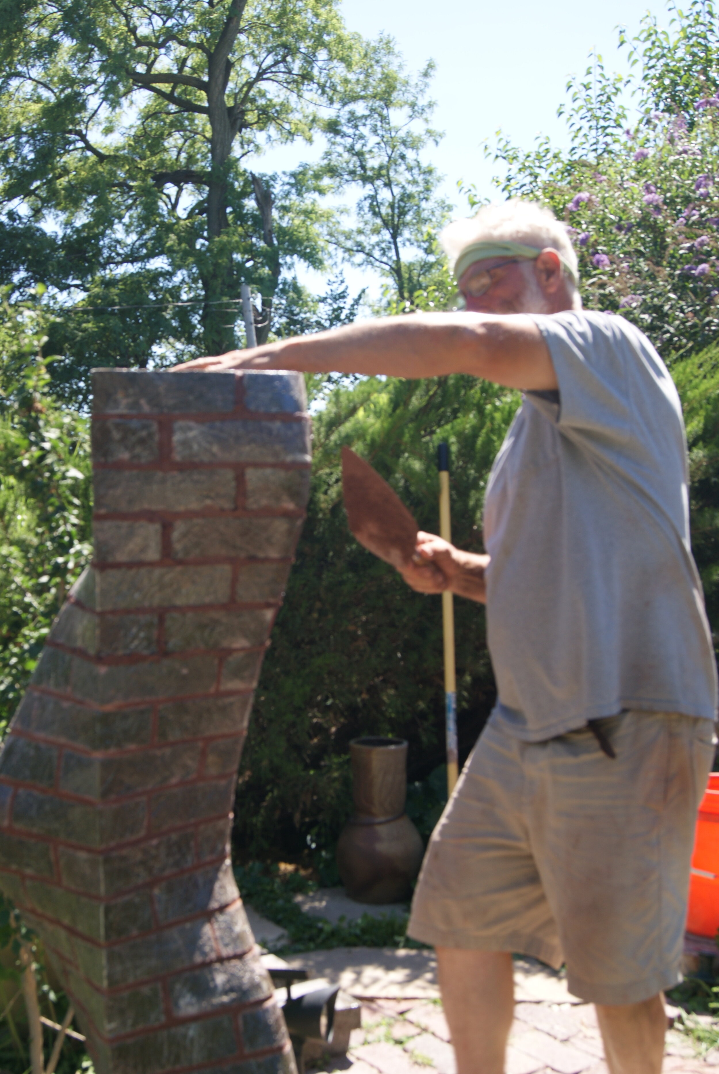 Michael Morgan building garden column of carved brick