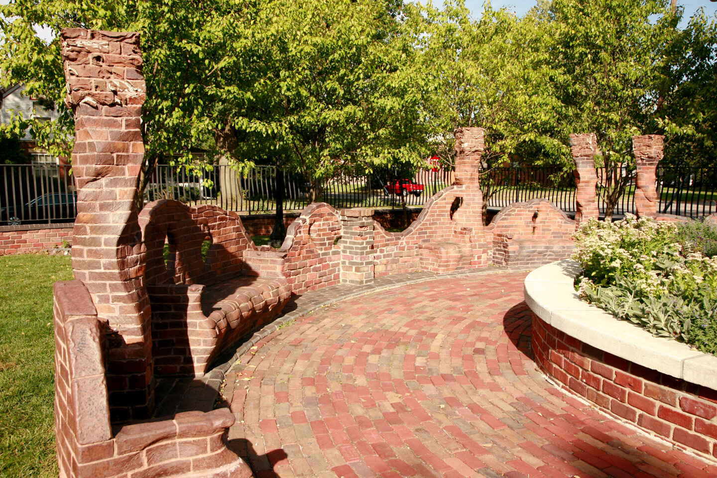 Built in bench of carved brick, part of Cer installation in park.