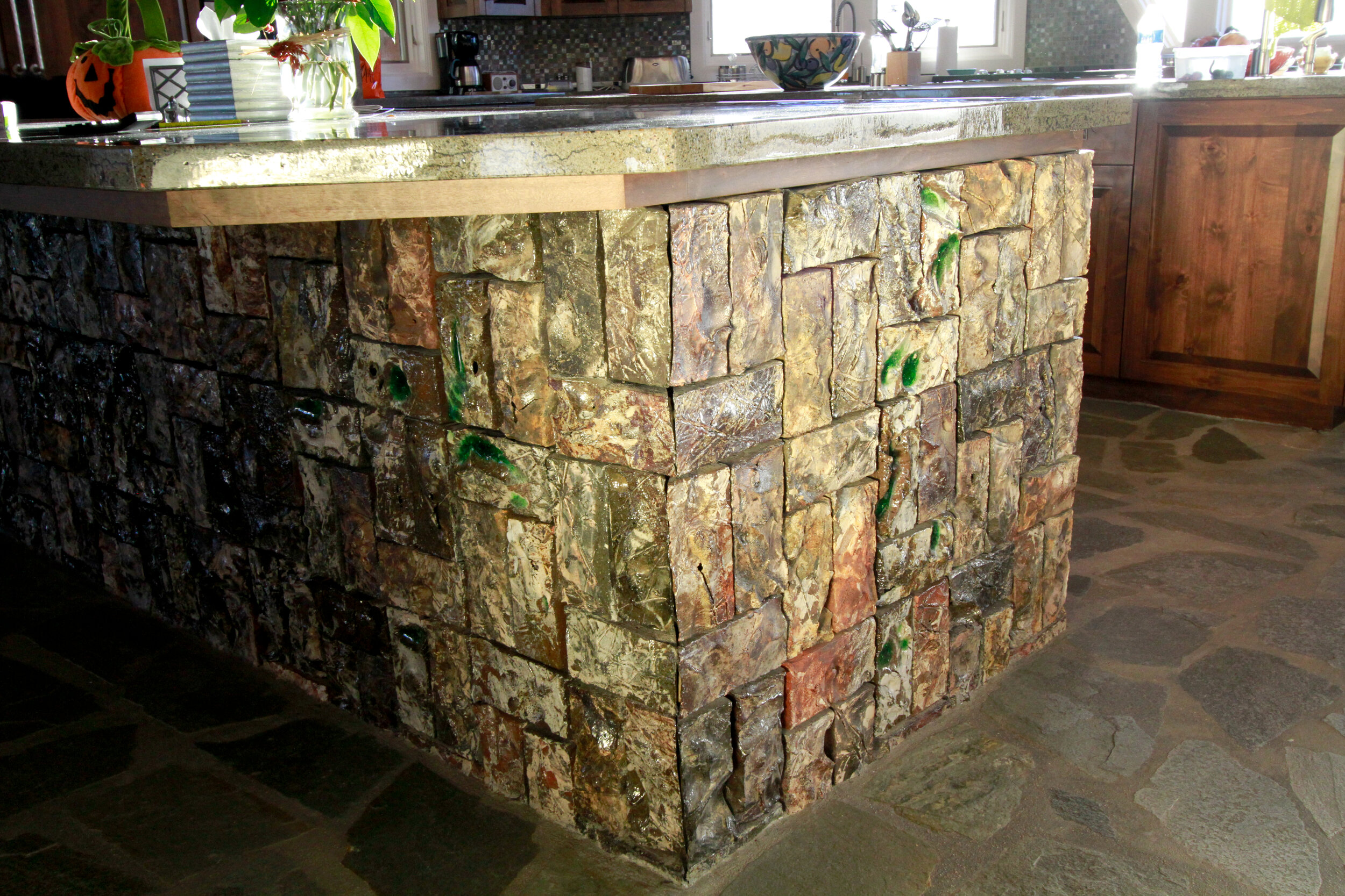 Kitchen island covered with carved colored bricks