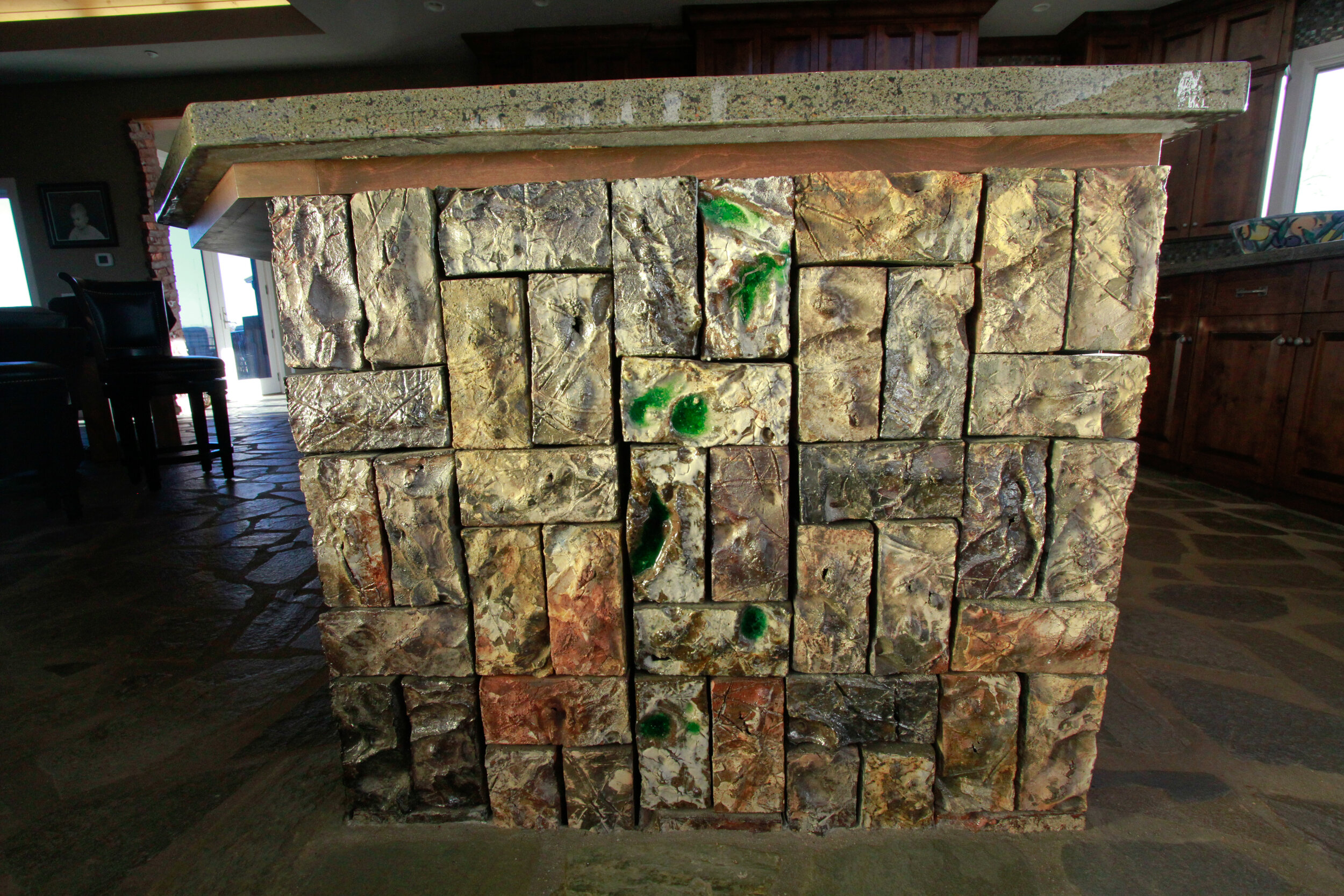 Carved bricks adorn front of kitchen island