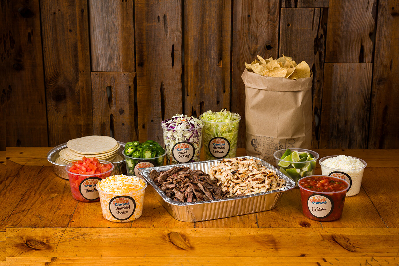 Catering trays of meat, veggies, chips and tortillas