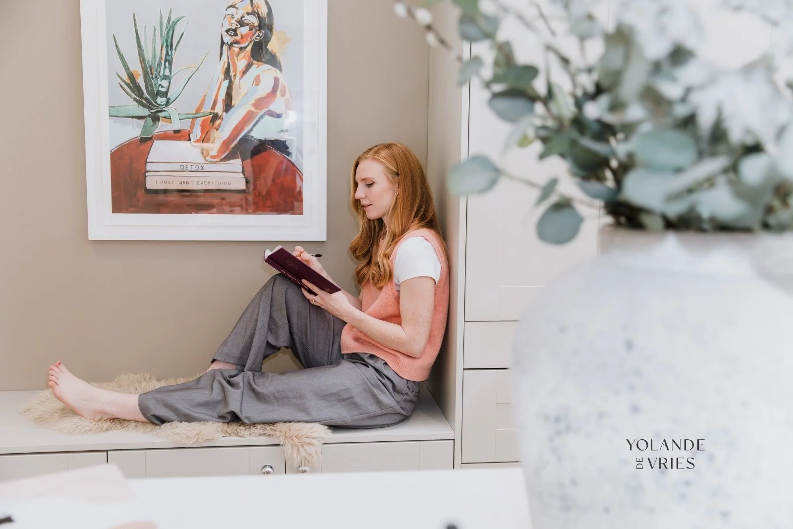 Nutritionist wriing in a notebook in kitchen nook