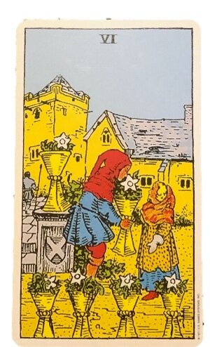 Image provided by Hetty Roi. Alt text: The card contains six cups, each containing a a white flower and some greenery. A child gives one cup to another, while in the background two yellow houses stand before a blue sky.