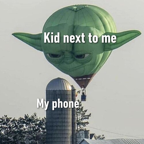A meme by 9GAG.Alt Text: A giant hot air balloon shaped like Yoda’s face is staring intently at a grey silo. The Yoda balloon has the words ‘Kid next to me’ in a blocky white font superimposed on it, and the silo has the words ‘My phone’ on it.