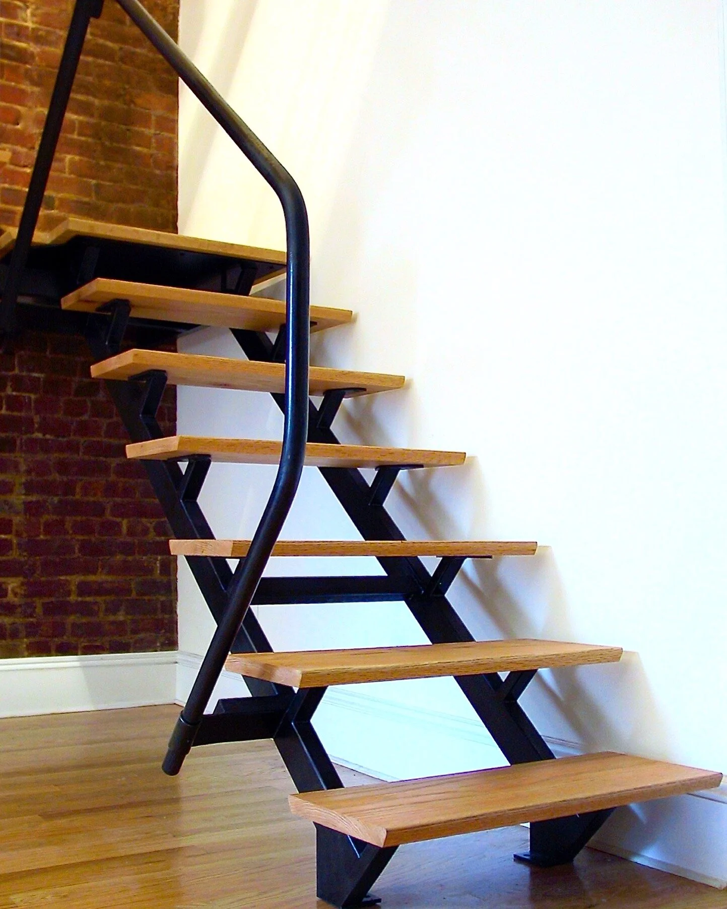 Switchback steel frame stair and handrail with wood treads